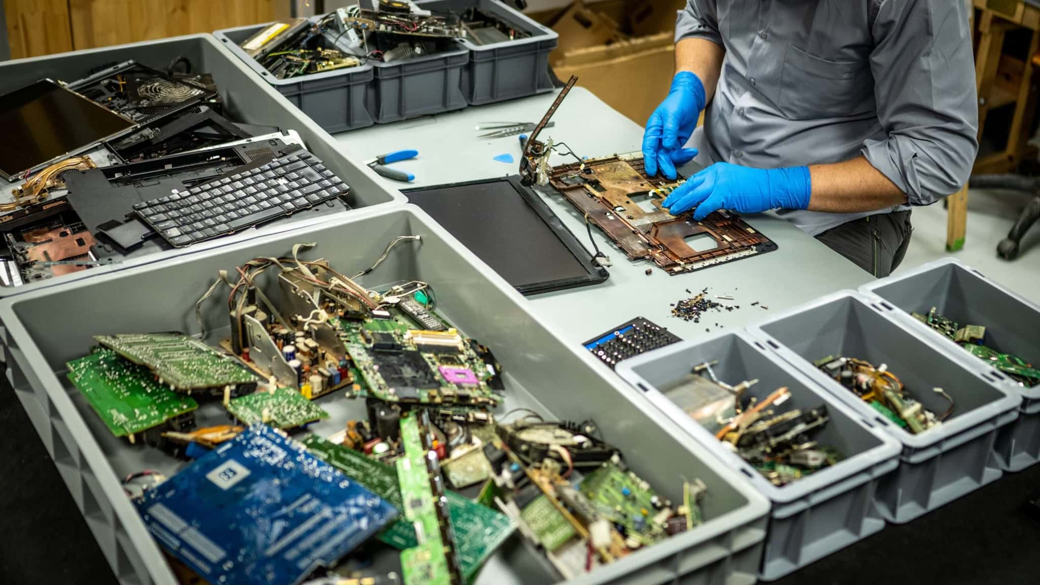 IT asset disposal (ITAD) worker recovering valuable components from electronic waste, e-waste